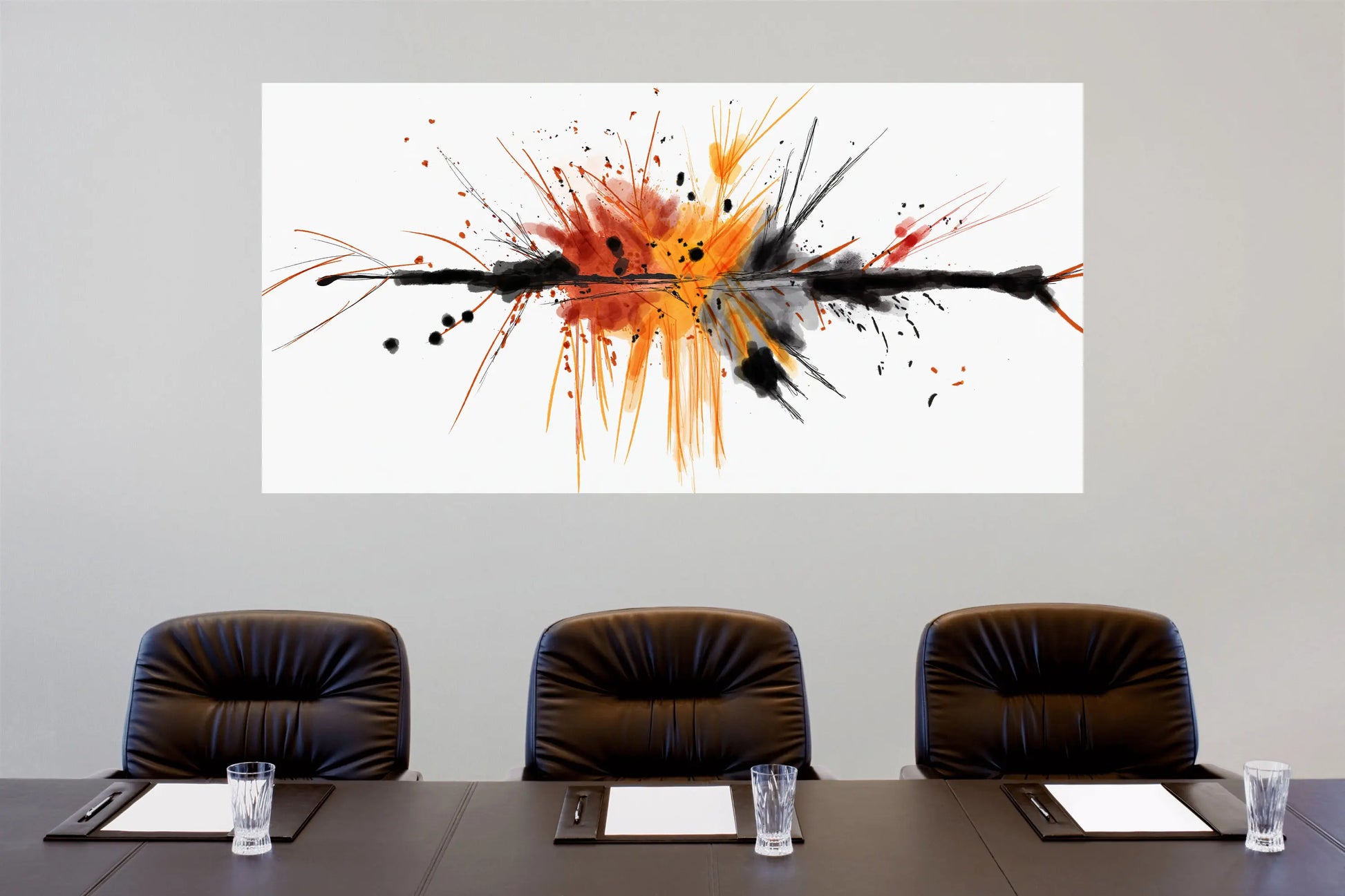 Abstract art piece on a wall above a conference table with chairs.