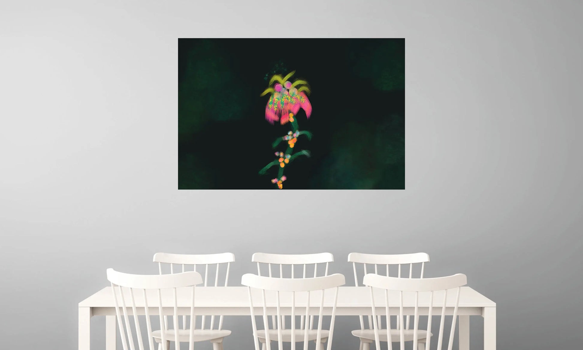 Framed artwork of a colorful flower on a gray wall above a white table with chairs.