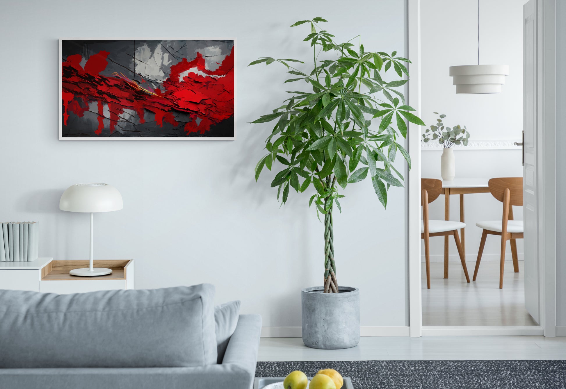 Modern living room with a gray sofa, plant, and abstract art on the wall.