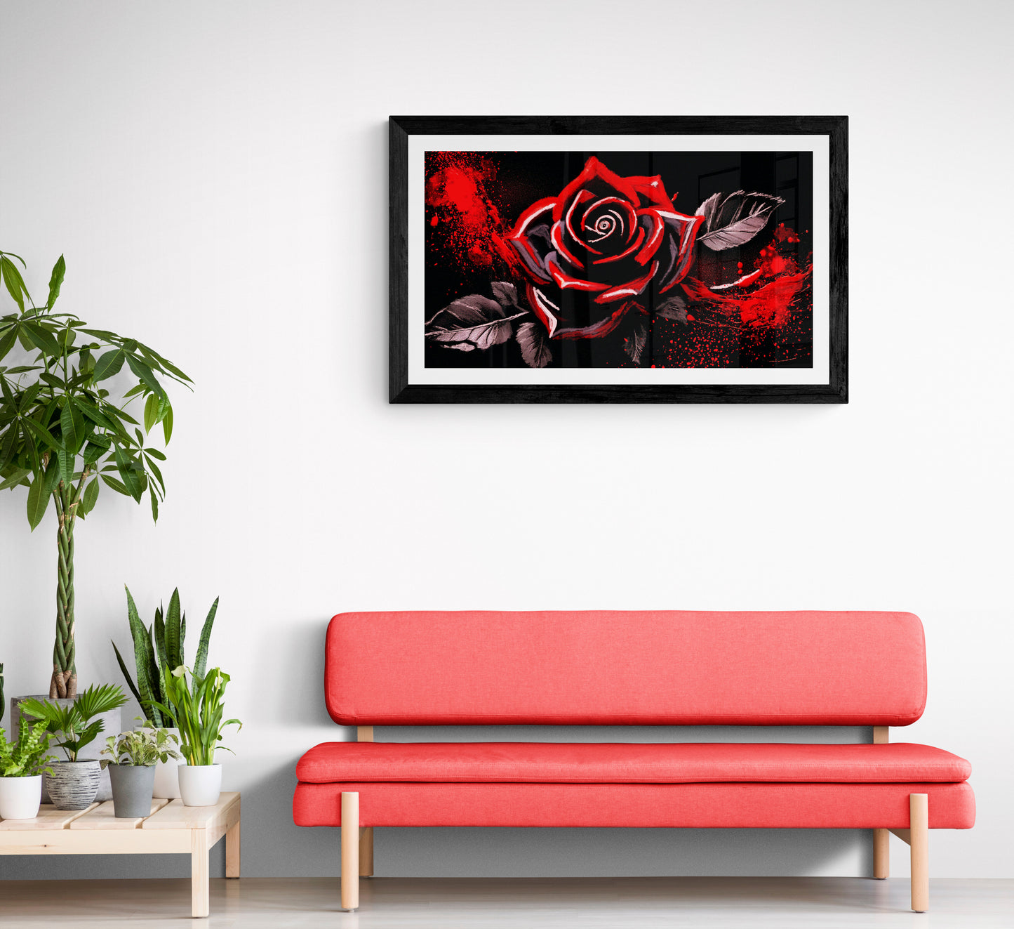 Red sofa in a room with a framed artwork of a red rose on the wall.