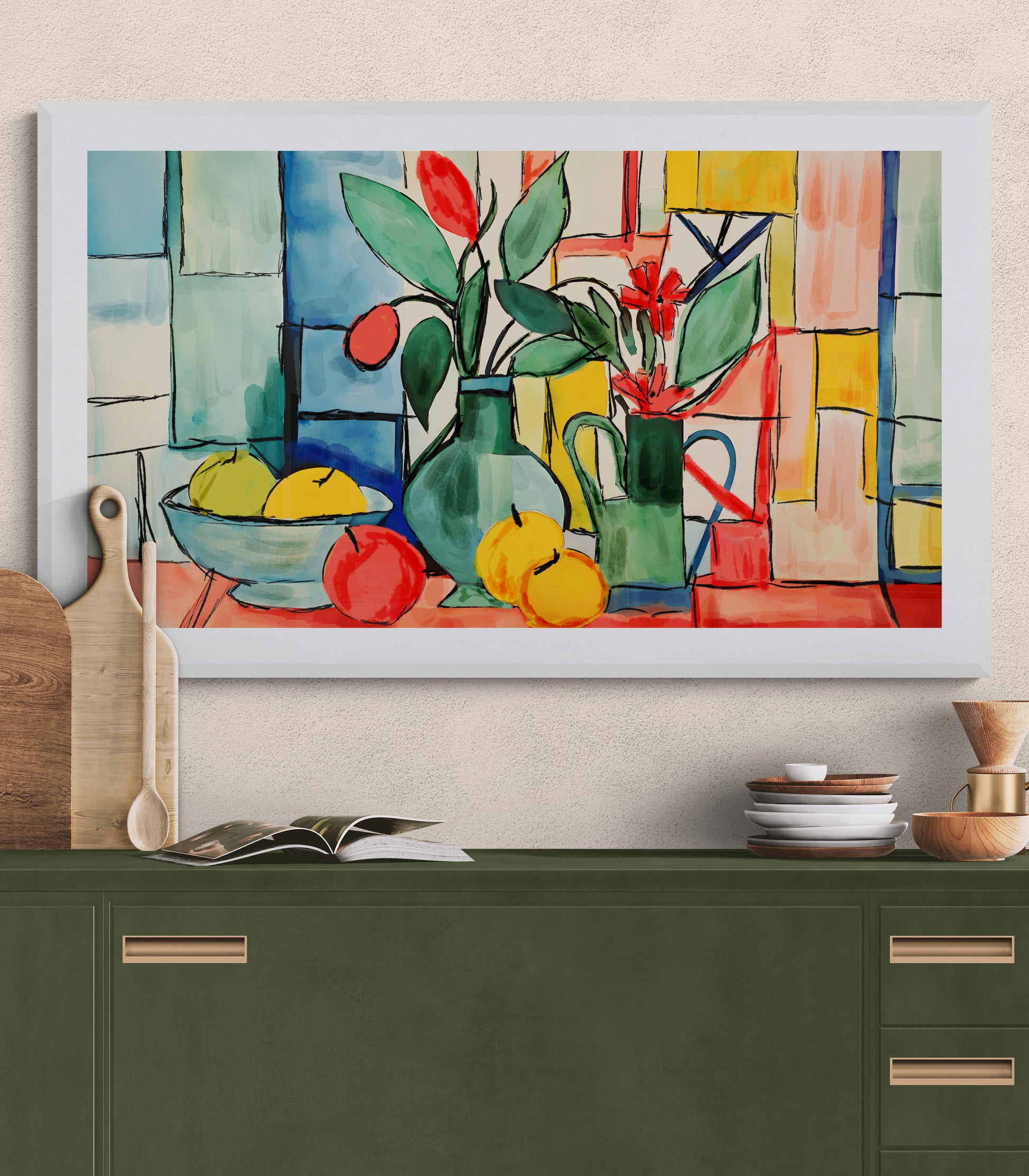 Framed still life painting with fruits and flowers on a wall above a green cabinet.