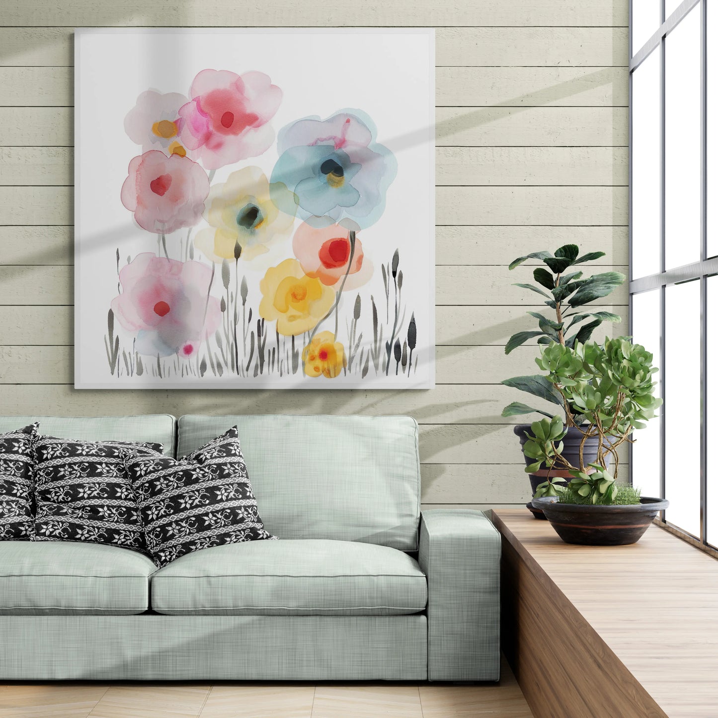 Floral painting above a gray sofa with decorative pillows in a modern living room.