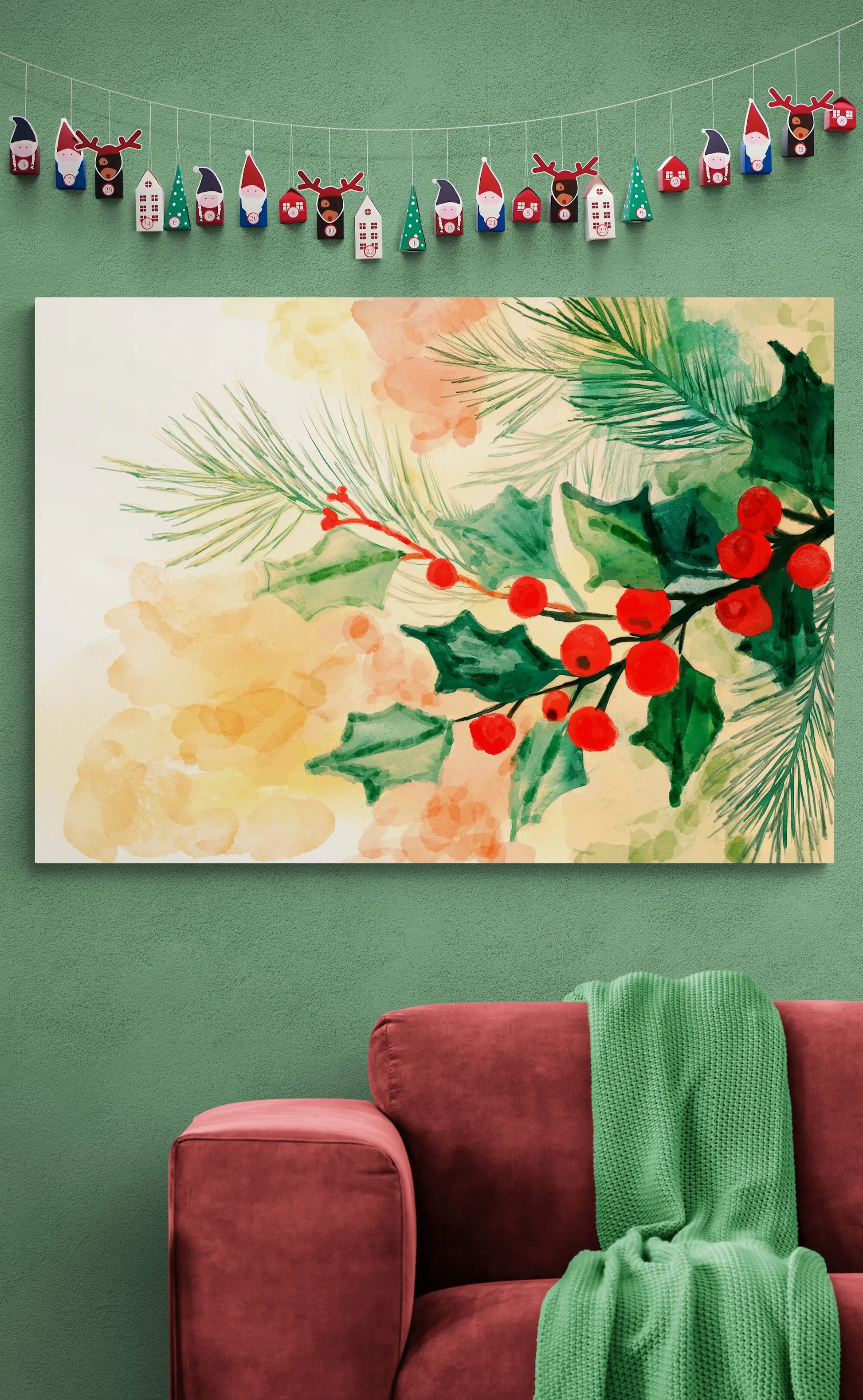Decorative wall art with holly berries and flowers on a green wall above a red couch.