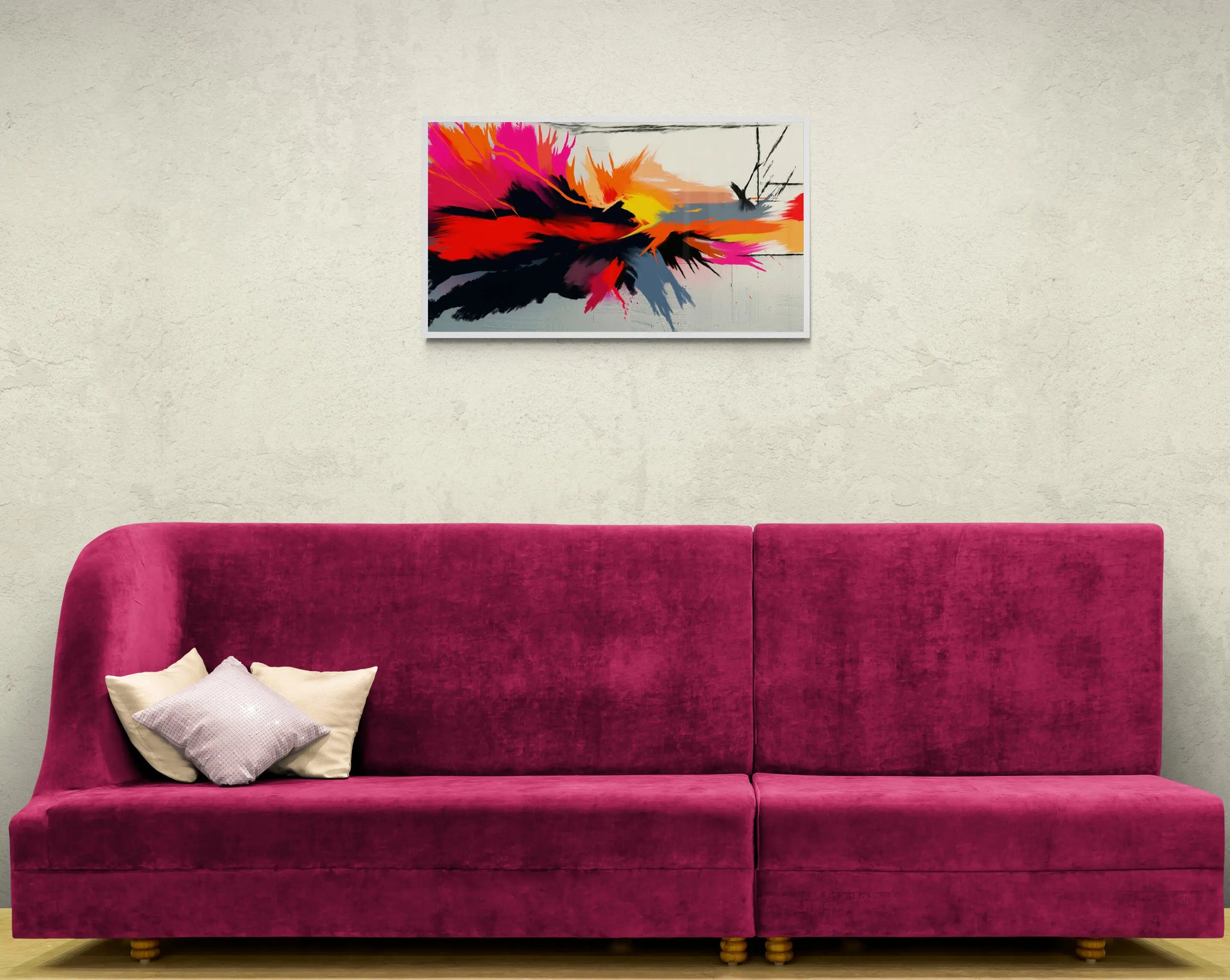 Pink sofa with white pillows against a light gray wall with a colorful abstract painting.