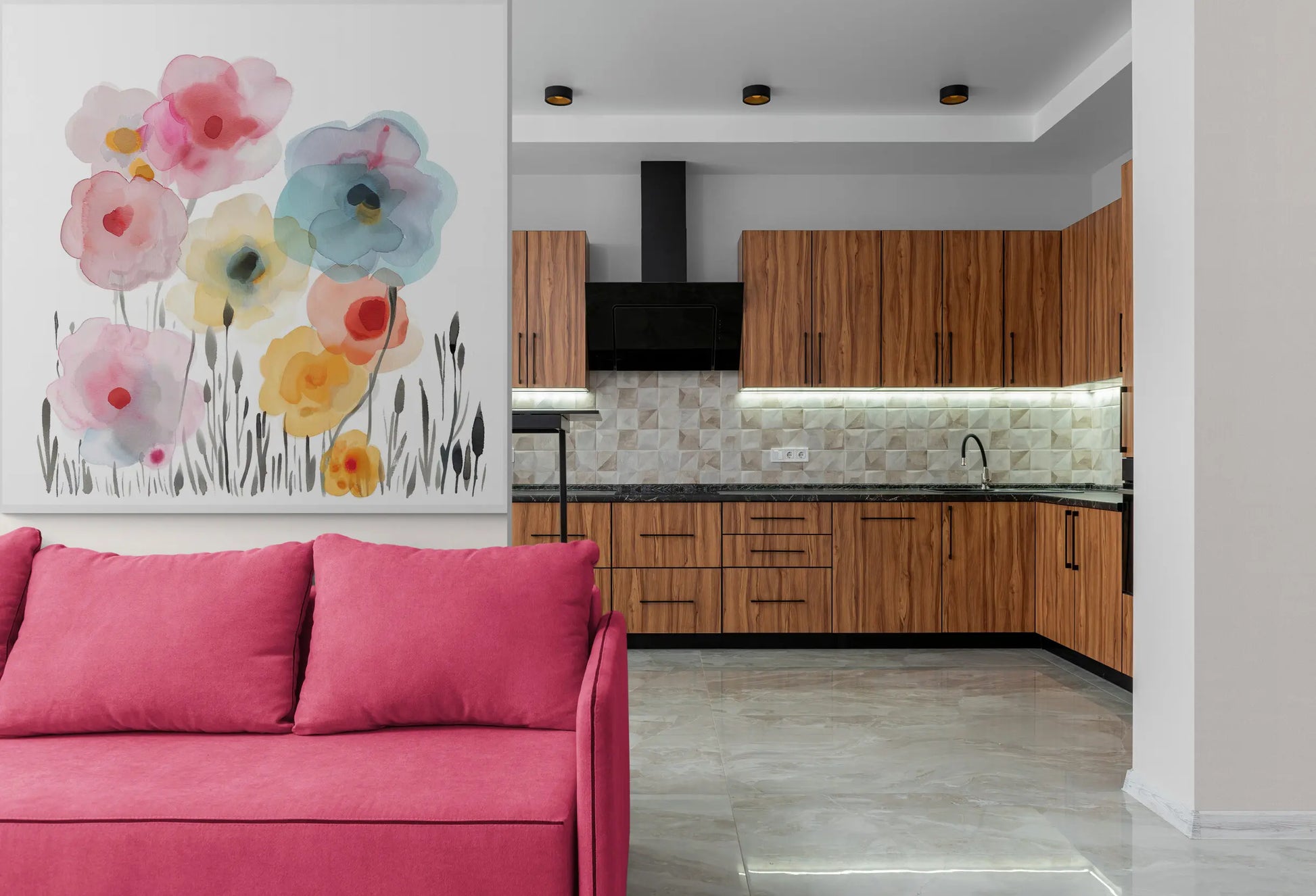 Modern kitchen with pink sofa and floral artwork on the wall.
