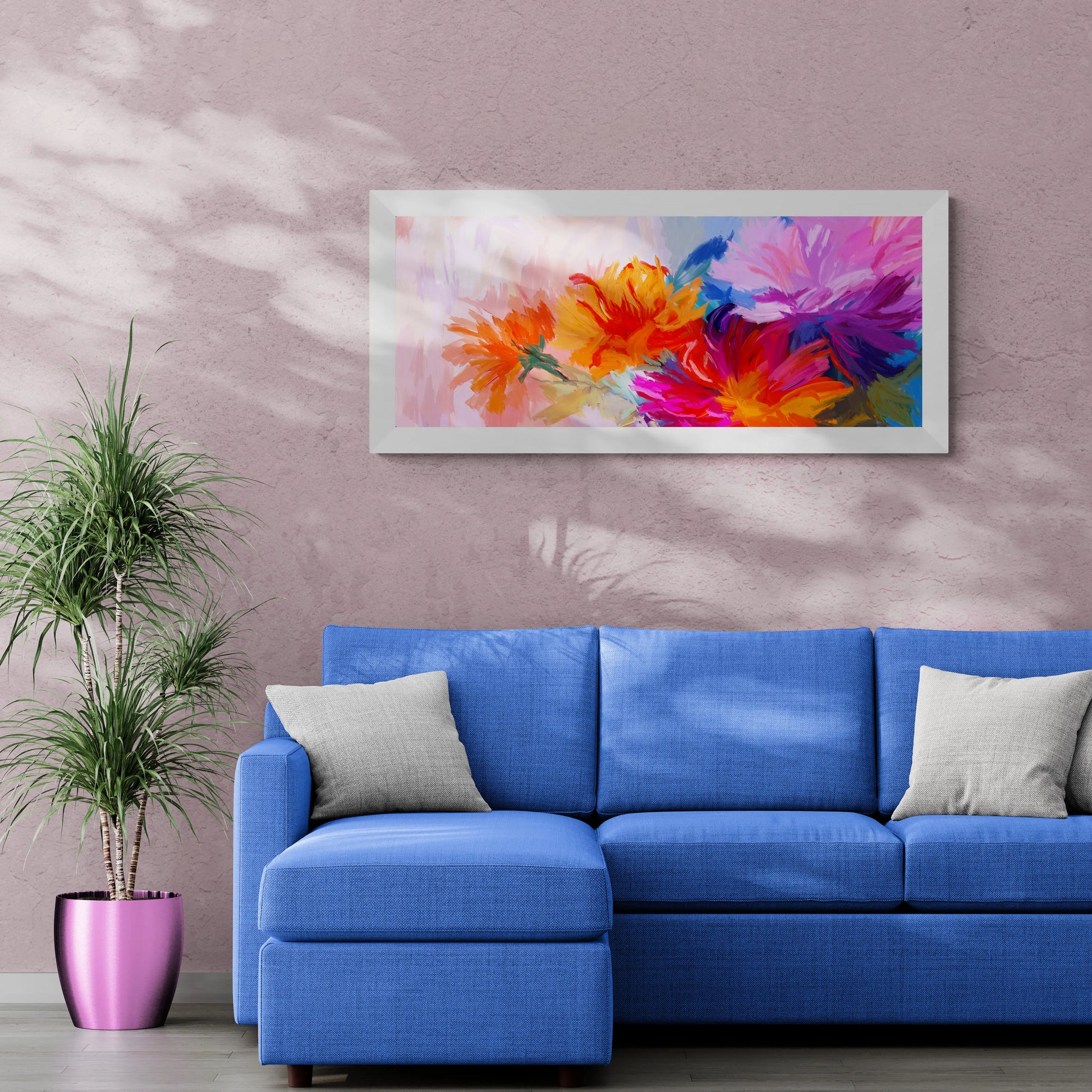Blue sofa in a living room with a colorful floral painting on the wall.