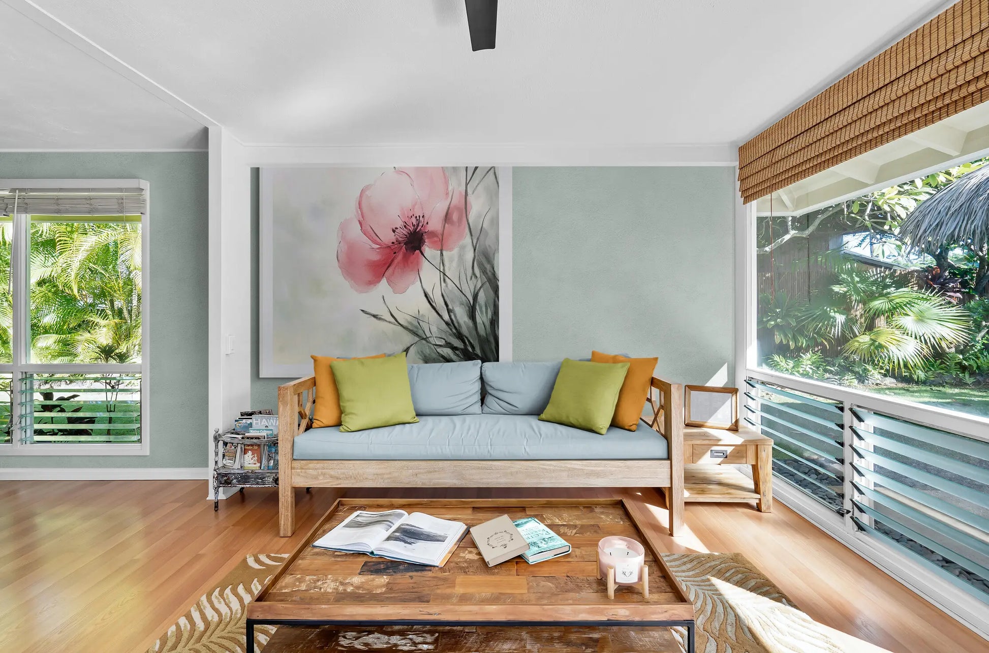 Living room with a couch, coffee table, and large windows with outdoor views.