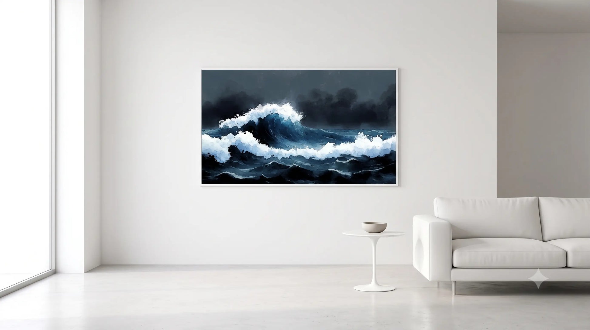 A framed wall art print depicting a dramatic dark blue and white ocean wave, displayed on a white wall in a modern minimalist living room with a white sofa and side table.
